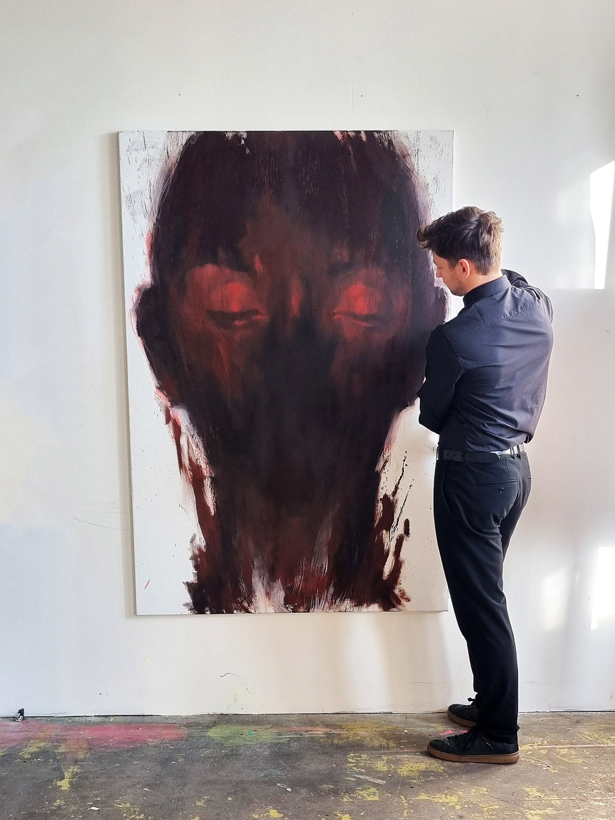 Abstract portrait painting with black base and vibrant colored brushstrokes expressing intense emotions